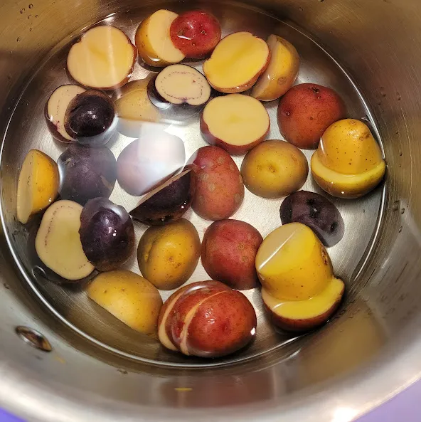 Sliced Potatoes in a cold pot of water for WFPBnO Pierogies