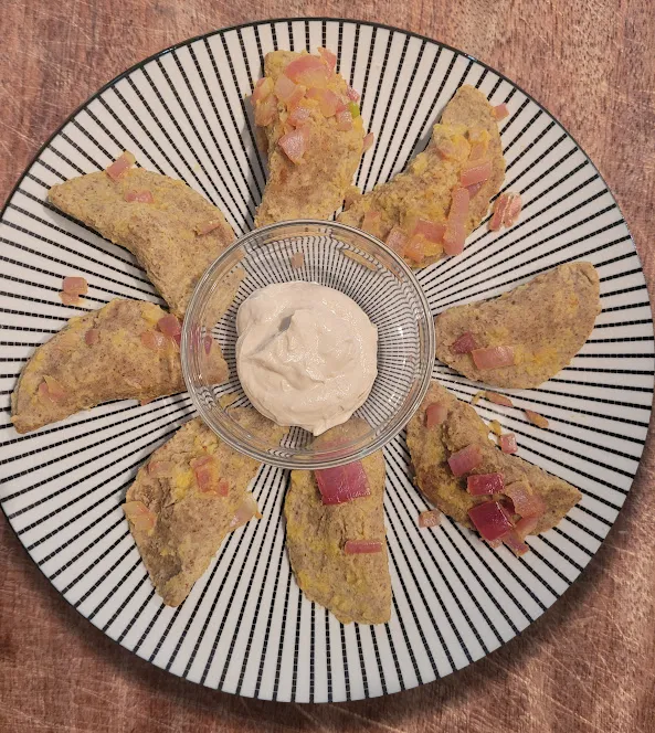 Plant-based gluten free pieroges filled with WFPBnO vegan cheese potatoes, covered in cauliflower butter and tahini sour cream!